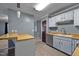 Well-lit kitchen area with modern appliances, light-colored cabinets, and tiled flooring at 71 Romans Rd, Roxboro, NC 27574