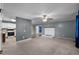 Open concept living room with a white painted brick fireplace, adjacent to the kitchen at 71 Romans Rd, Roxboro, NC 27574