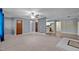 Living room with ceiling fan, carpet, adjacent to kitchen with bar seating at 71 Romans Rd, Roxboro, NC 27574