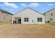 Backyard featuring patio with grill, grassy area, and well-maintained siding, great for outdoor enjoyment at 909 Sea Holly Dr, Zebulon, NC 27597