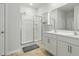 Bathroom featuring a walk-in shower, double sink vanity, and bright lighting at 909 Sea Holly Dr, Zebulon, NC 27597