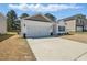 Attractive single-Gathering home showcasing a well-manicured lawn and a double car garage at 909 Sea Holly Dr, Zebulon, NC 27597