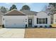 Charming single-story home with white siding, black shutters, and well-maintained lawn at 909 Sea Holly Dr, Zebulon, NC 27597