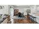 Eat-in kitchen featuring stainless steel appliances, a center island with barstool seating, and wood floors at 909 Sea Holly Dr, Zebulon, NC 27597