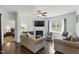 Comfortable living room with a fireplace, ceiling fan, and plenty of natural light at 909 Sea Holly Dr, Zebulon, NC 27597