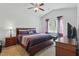 Cozy bedroom with a large window, ceiling fan, and comfortable furnishings at 909 Sea Holly Dr, Zebulon, NC 27597