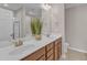 Bathroom featuring double sinks, wood cabinets, and a large mirror reflecting the clean, bright space at 946 Consortium Dr, Raleigh, NC 27603