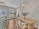 Bright dining area featuring modern lighting, natural wood table, and access to outdoor patio at 946 Consortium Dr, Raleigh, NC 27603