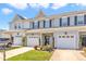 Charming townhome featuring a one car garage, covered entrance, and neatly manicured landscaping at 946 Consortium Dr, Raleigh, NC 27603