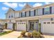 Charming townhome featuring a one car garage, covered entrance, and neatly manicured landscaping at 946 Consortium Dr, Raleigh, NC 27603