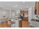 Contemporary kitchen with granite countertops, breakfast bar, stainless steel appliances, and wood cabinets at 946 Consortium Dr, Raleigh, NC 27603