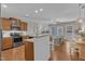 Open-concept kitchen with stainless steel appliances and granite countertops flowing into the living area at 946 Consortium Dr, Raleigh, NC 27603