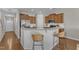 Modern kitchen boasts stainless steel appliances, breakfast bar, granite countertops, and ample cabinet space at 946 Consortium Dr, Raleigh, NC 27603