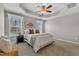 Comfortable main bedroom boasts a tray ceiling, plush carpeting, and bright windows with natural light at 946 Consortium Dr, Raleigh, NC 27603