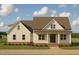 Charming home featuring a welcoming front porch, a mix of textures, and a well-manicured lawn at Lot 10H Good Shepherd Trl, Spring Hope, NC 27882
