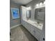 Bathroom boasts double sinks, granite countertops, and a shower-tub combination at Lot 14H Good Shepherd Trl, Spring Hope, NC 27882