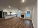 Open-concept living space featuring a fireplace, hardwood floors, and views into the modern kitchen at Lot 14H Good Shepherd Trl, Spring Hope, NC 27882