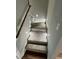 Carpeted stairway with wooden handrail and wall-mounted lights at Lot 14H Good Shepherd Trl, Spring Hope, NC 27882
