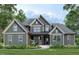 Charming two-story home featuring gray siding, a covered porch, and meticulously landscaped front yard at Lot 22H Good Shepherd Trl, Spring Hope, NC 27882