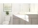 Well-lit bathroom with a gray vanity cabinet, modern art, and a sleek toilet design at 1004 Red Roses Ave, Durham, NC 27703