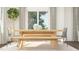 Bright dining area with a modern wooden table, bench, and stylish decor at 1004 Red Roses Ave, Durham, NC 27703