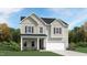 Charming two-story home with gray siding, stone accents, and a welcoming front porch at 1004 Red Roses Ave, Durham, NC 27703
