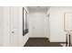 Clean hallway with neutral colors, modern art, and access to multiple rooms at 1004 Red Roses Ave, Durham, NC 27703