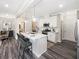 Modern kitchen features white cabinets, quartz countertops, stainless steel appliances, and pendant lighting at 1005 Red Roses Ave, Durham, NC 27703