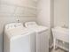 Efficient laundry room with white appliances and a convenient utility sink at 1005 Red Roses Ave, Durham, NC 27703