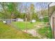 Fenced backyard with green grass and storage sheds at 1022 Glover Rd, Dunn, NC 28334