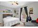 Cozy bedroom featuring a ceiling fan and a sunlit window at 1022 Glover Rd, Dunn, NC 28334