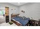Bedroom with shiplap wall and barn door access at 1022 Glover Rd, Dunn, NC 28334