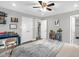 Neutral bedroom with updated flooring features a ceiling fan, closet, and a desk area at 1022 Glover Rd, Dunn, NC 28334