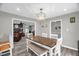 Cozy dining room with a wood table, bench seating, modern light fixture, and an open layout at 1022 Glover Rd, Dunn, NC 28334