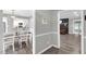 Open-concept dining area with stylish lighting, wood floors, and views into the kitchen and living room at 1022 Glover Rd, Dunn, NC 28334