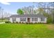 Charming single-story home with a well-maintained lawn, tidy landscaping, and a red front door at 1022 Glover Rd, Dunn, NC 28334