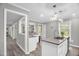Bright kitchen features a central island, granite countertops, updated lighting, and stainless steel appliances at 1022 Glover Rd, Dunn, NC 28334