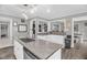 Bright kitchen with white cabinets, stainless steel appliances, and an island with granite countertop at 1022 Glover Rd, Dunn, NC 28334