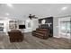 Cozy living room with a ceiling fan, fireplace, leather furniture, and built-in bookshelves at 1022 Glover Rd, Dunn, NC 28334