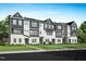A group of new townhomes with a black and white color scheme in a community at 1034 Zelkova Ln, Chapel Hill, NC 27517