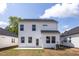 White vinyl sided two-story home with grass lawn, concrete patio, surrounded by other homes and a blue sky at 104 Fairwinds Dr, Lillington, NC 27546