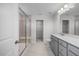 Bathroom with a glass shower, dual vanity sinks, and ample storage space at 104 Fairwinds Dr, Lillington, NC 27546