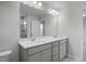 Elegant bathroom featuring double sinks, sleek gray cabinetry, and a large framed mirror at 104 Fairwinds Dr, Lillington, NC 27546
