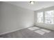 Cozy bedroom with large windows casting sunlight, complemented by soft carpeting at 104 Fairwinds Dr, Lillington, NC 27546
