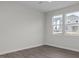 Minimalist bedroom with wood-look flooring and lots of natural light at 104 Fairwinds Dr, Lillington, NC 27546
