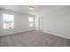 Carpeted bedroom with ample natural light from two windows overlooking the neighborhood at 104 Fairwinds Dr, Lillington, NC 27546