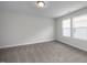 Bright bedroom with carpet, two windows, and natural light at 104 Fairwinds Dr, Lillington, NC 27546