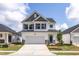 Charming two-story home with a two-car garage, gray accents, and a well-manicured lawn at 104 Fairwinds Dr, Lillington, NC 27546