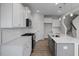 Open kitchen featuring white cabinets, countertops, and stainless steel appliances at 104 Fairwinds Dr, Lillington, NC 27546