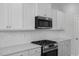 Detailed shot of a modern kitchen with stainless steel appliances and white cabinets at 104 Fairwinds Dr, Lillington, NC 27546